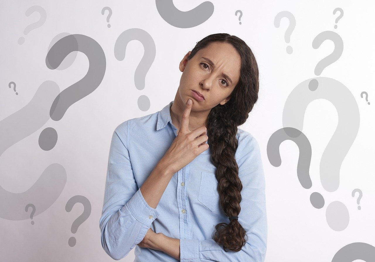 Confused woman with question mark background